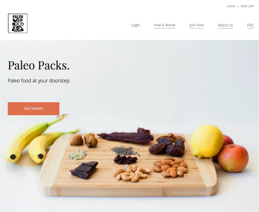 Paleo Packs home page: "Paleo food at your doorstep" above a cutting board of fruit, nuts, and dark chocolate, with a Get Started button